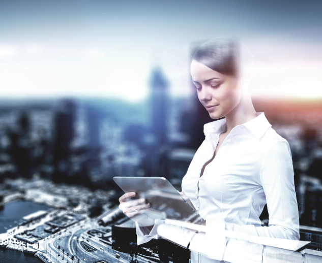 Beautiful elegant businesswoman against cityscape using tablet computer